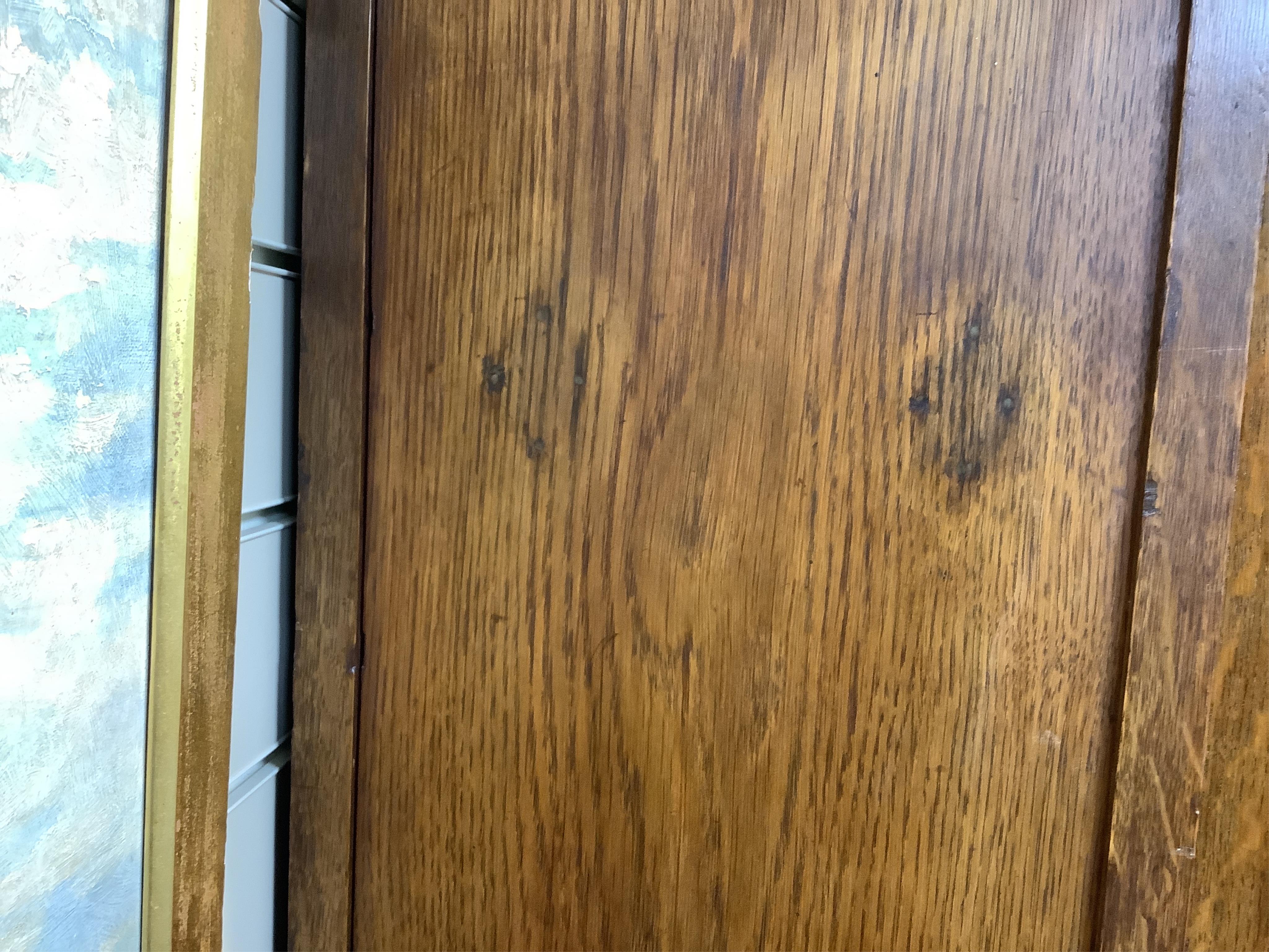 Manner of Liberty & Co: An Arts and Crafts embossed copper mounted oak hall cupboard